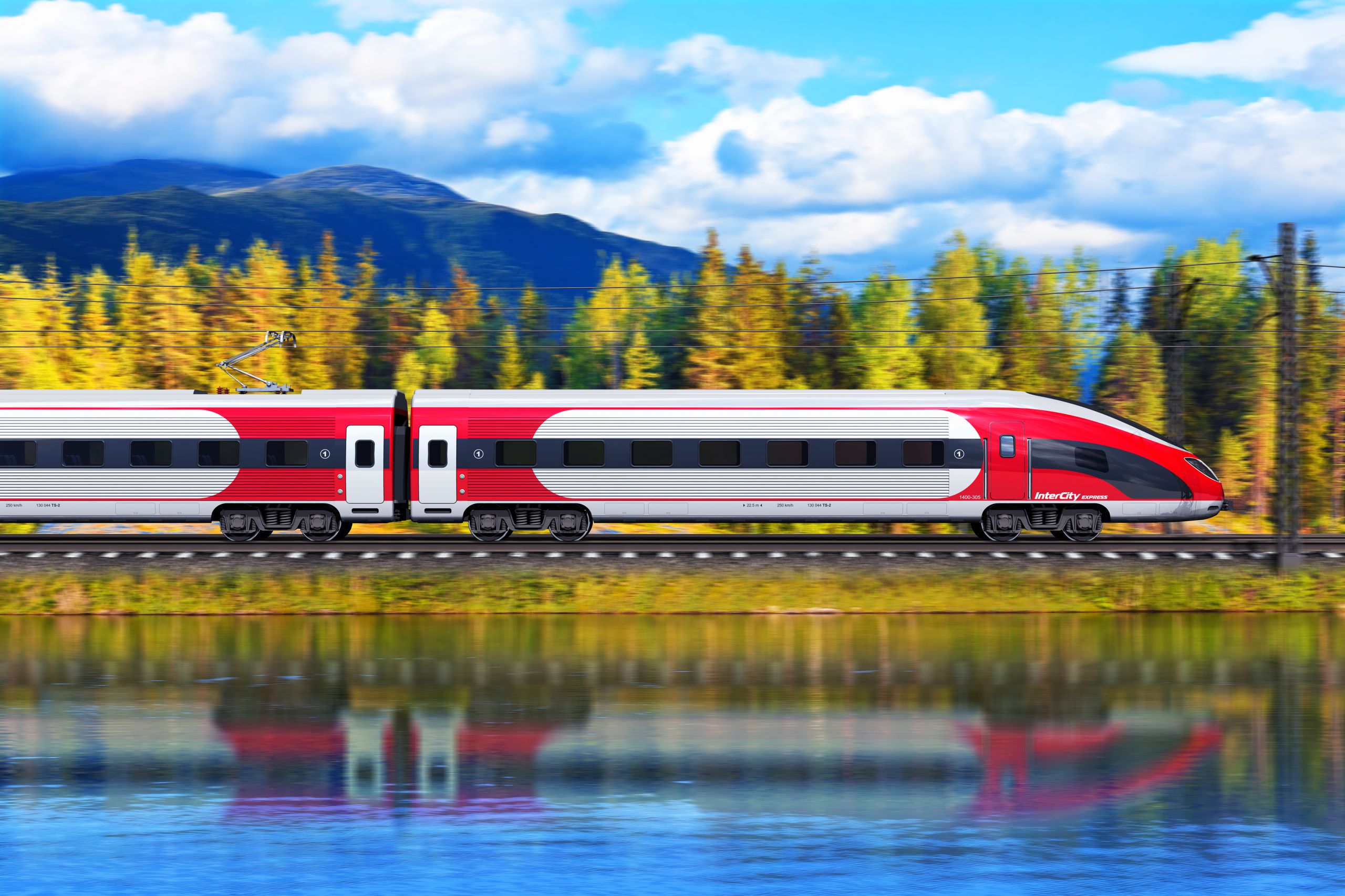 A high-speed train crossing a mountain valley beside a lake
