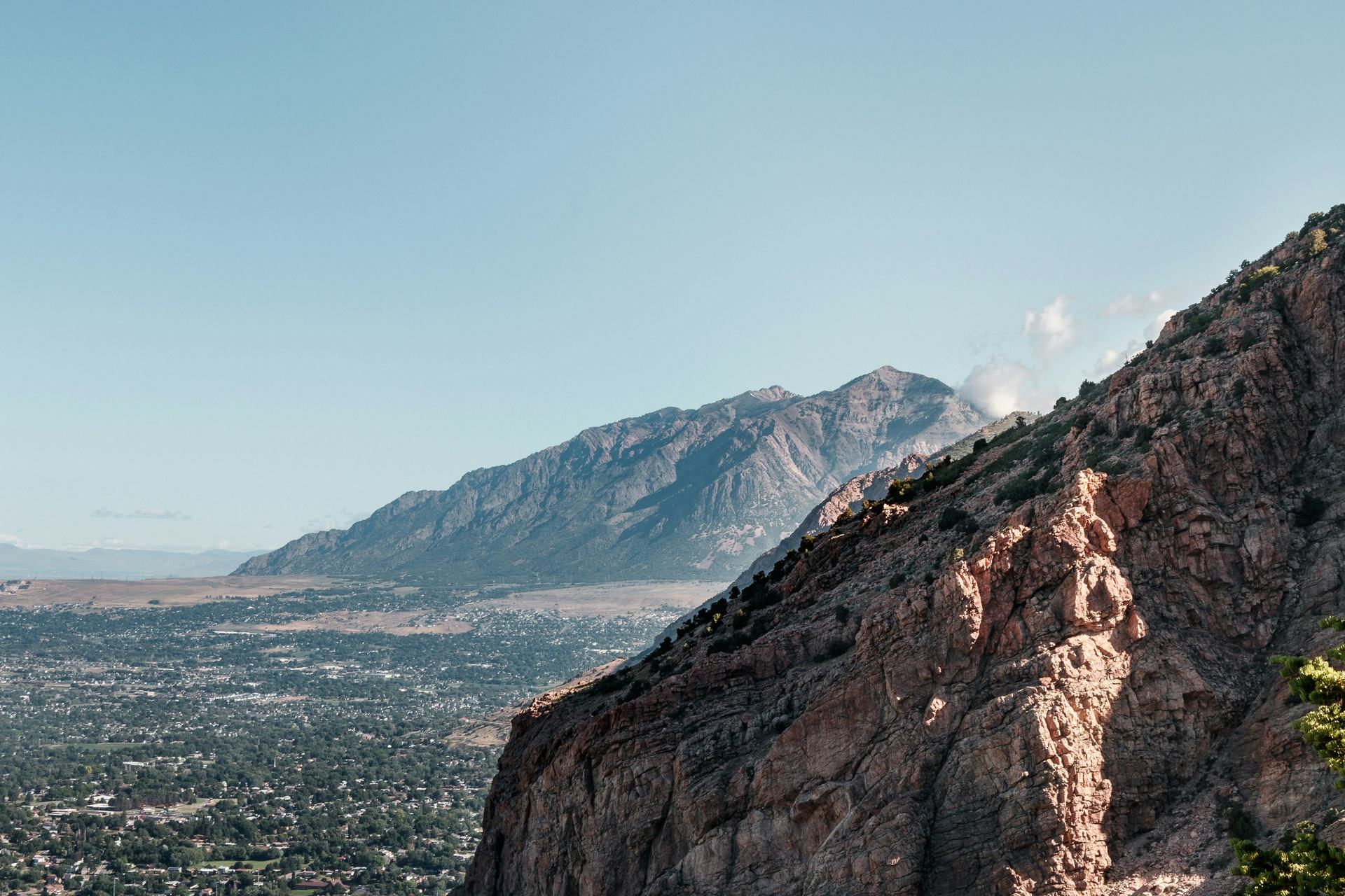 The Wasatch Front above Ogden, with red rock cliffs in the foreground and the city spread across the valley below